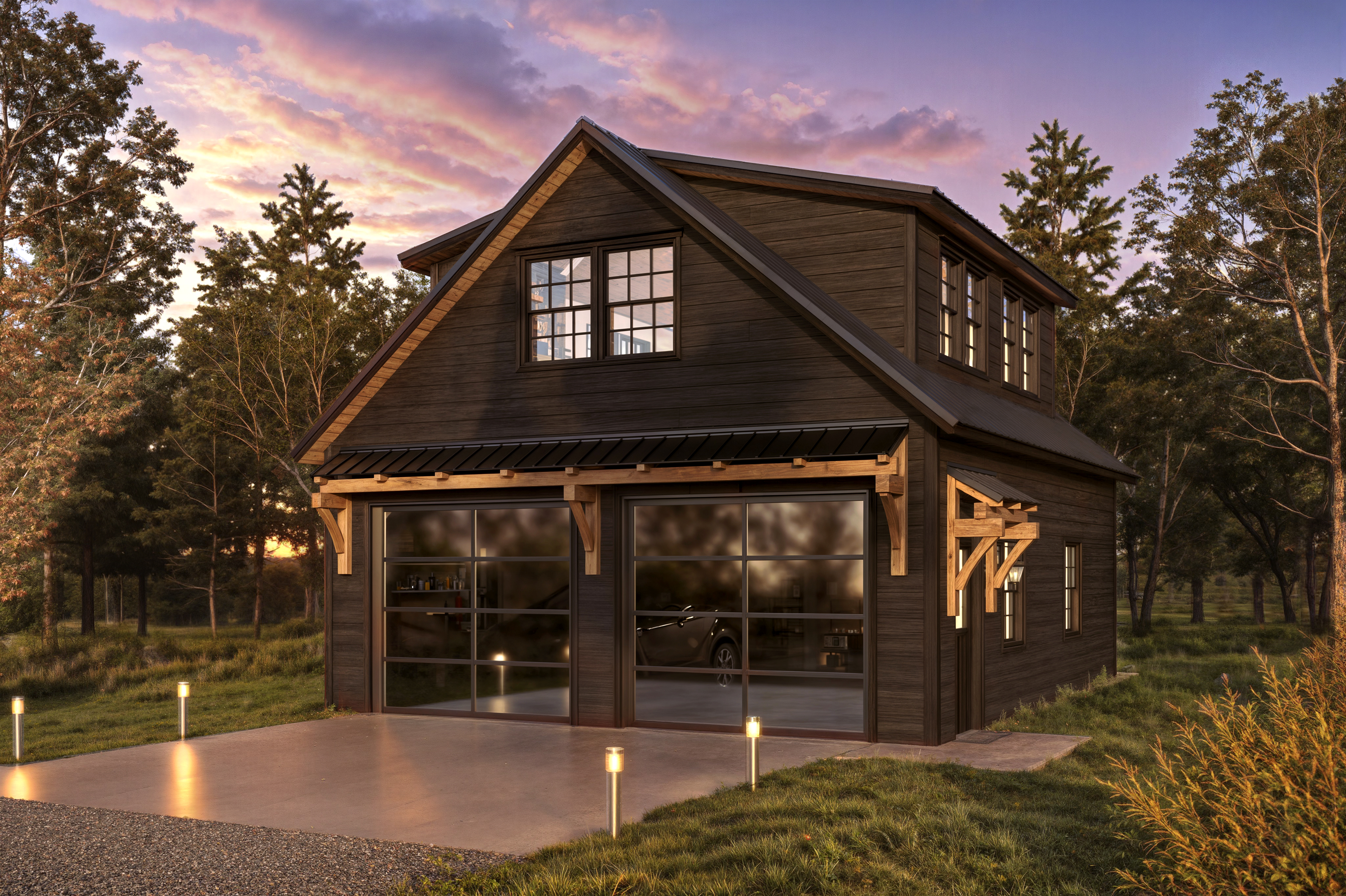 Dark wood two-story garage with timber frame accents at sunset