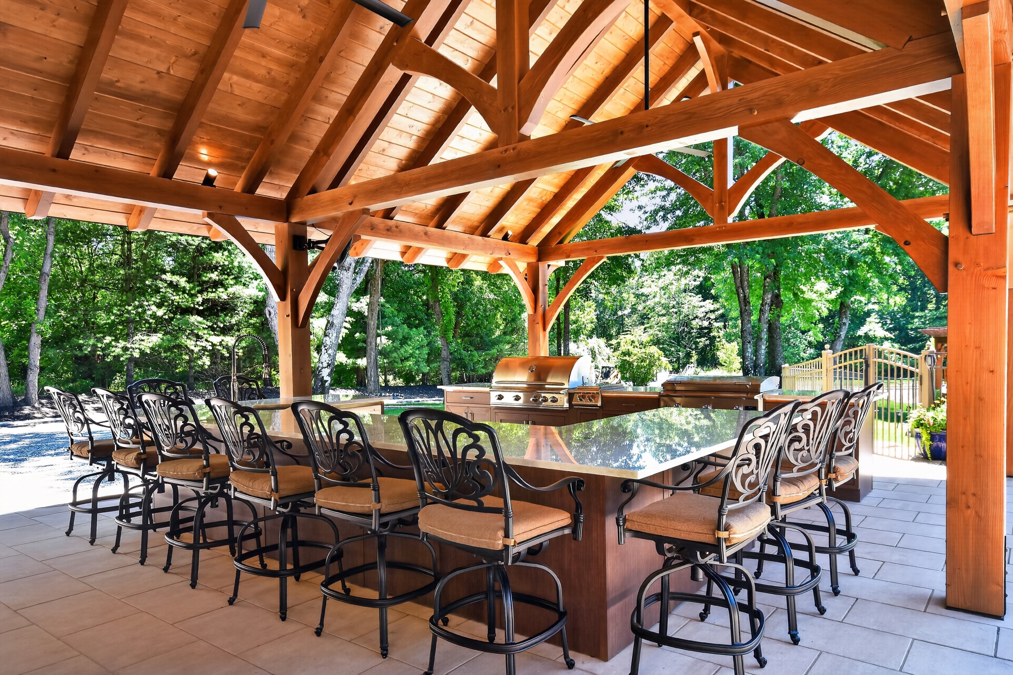 Two-story garage with stone base, wood garage doors, and dormers with cupola