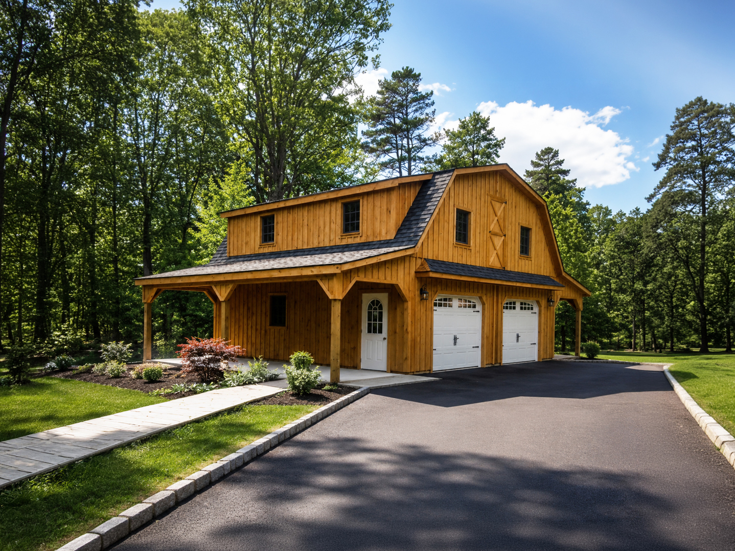 Modern gray and wood two-car garage with concrete driveway and landscaping