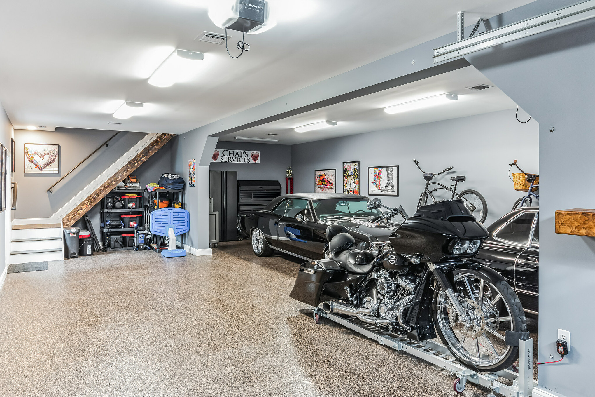 Finished garage loft game room with ping pong table and staircase